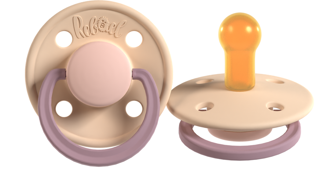 Two baby pacifiers with different designs on a white background