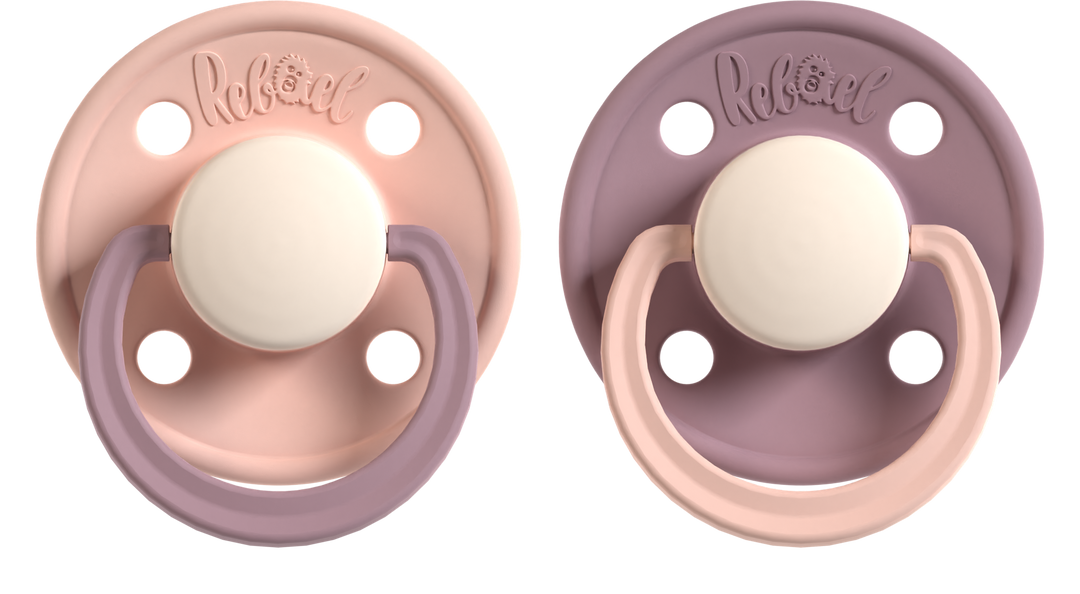 Two baby pacifiers with a soft pink and purple design on a white background.